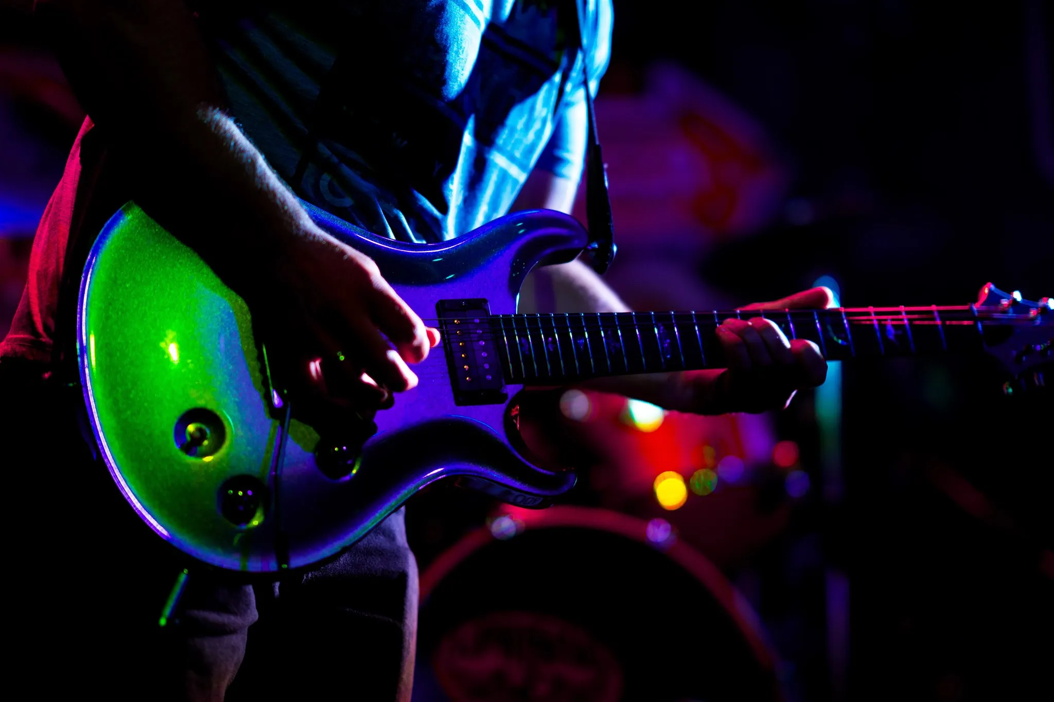 Close image of a guitar being played by Luke